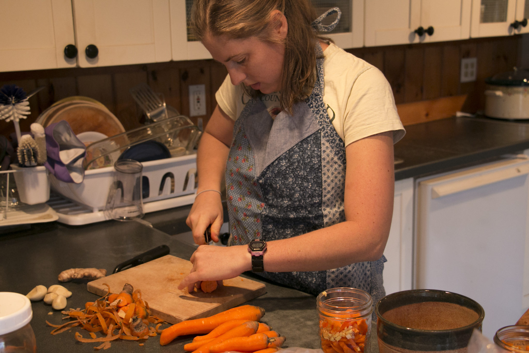 Mary Margaret Ripley chops carrots in preparation to make fermented vegetables in jars with ginger, curry powder and brine at her home, Ripley Farm, in Dover-Foxcroft, Maine. | Aislinn Sarnacki