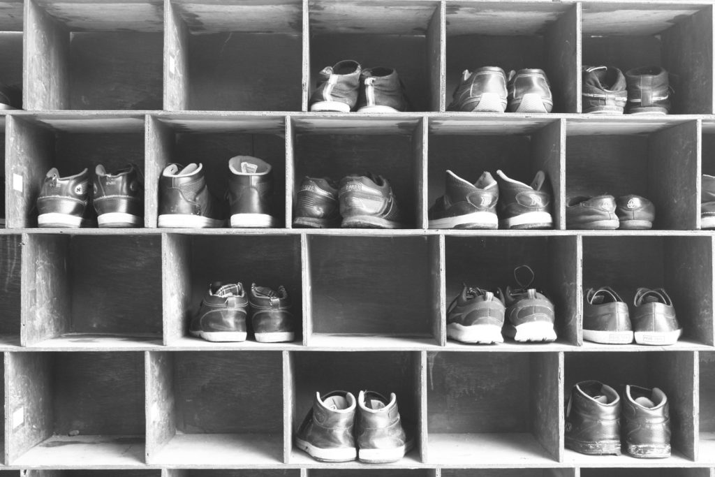 Pairs of shoes organized in a rack.