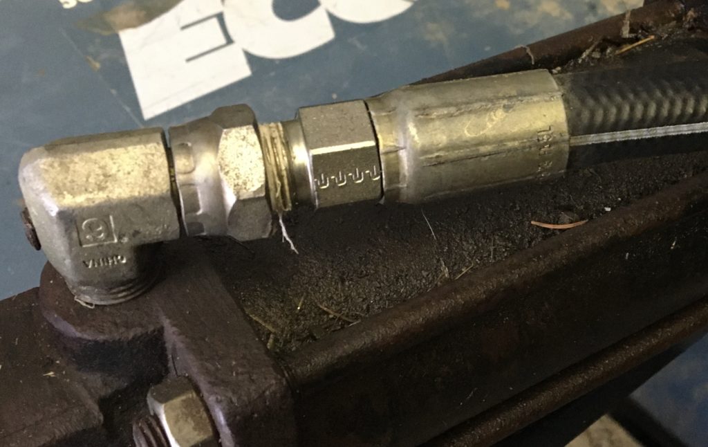 Closeup of a hydraulic line connected to a farm implement.